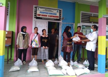 Penyerahan bantuan sembako kepada salah satu pedagang di kantin sekolah di Kabupaten OKI. (IST)