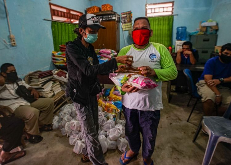 Koordinator Divisi Komite Etik PFI Palembang Mushaful Imam menyerahkan secara simbolis bantuan sembako dari XL Axiata dan PFI Palembang kepada anggota Pertuni Palembang, Jumat (08/05). (fornews.co/pfi palembang)