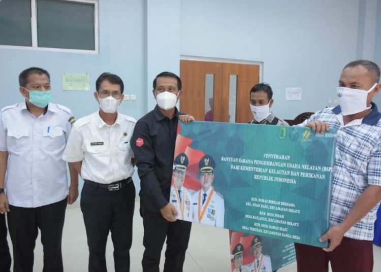 Ketua Komisi II DPRD Muba Muhammad Yamin menyerahkan secara simbolis bantuan dari KKP ke kelompok nelayan di Muba, Selasa (5/1/2021). (fornews.co/humas pemkab muba)