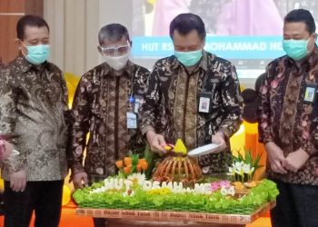 Dirut RSMH Palembang Bambang Eko Sunaryanto memotong tumpeng pada peringatan HUT ke-64 RSM Palembang, Jumat (8/1/2021). (fornews.co/humas rsmh palembang)