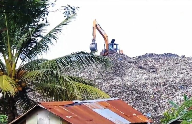 Alat berat berada di gunungan sampah di TPA Sukawinatan. (fornews.co/kominfo palembang)
