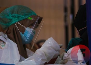 Petugas vaksinator sedang menyuntikkan vaksin Covid-19. (matakamera/fornews.co/mushaful imam)