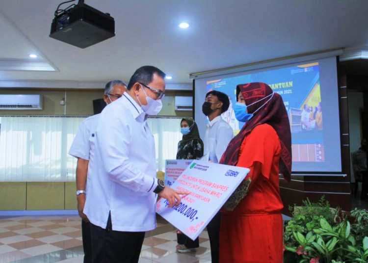 Bupati Muba Dodi Reza Alex menyerahkan BPUM kepada pelaku UMKM di auditorium Pemkab Muba, Kamis (6/5/2021). (fornews.co/humas pemkab muba)