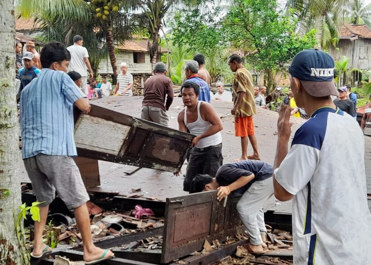 Warga Kelurahan Karang Jaya saat membersihkan rumah warga yang terdampak hantaman angin Puting Beliung, pada Senin (31/1/2022) malam. (fornews.co/ist)