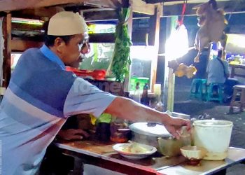 SAMIYO bersama gerobag bami jawa yang menemaninya setiap hari melayani pelanggan-pelanggan setianya. Foto diambil pada Jum'at, 14 November 2025. (foto fornews.co/adam)