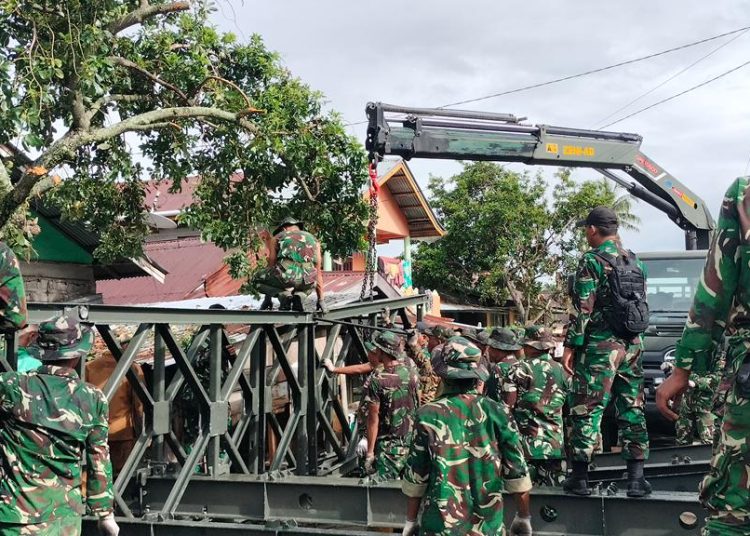 Sejumlah personel Yonzikon 12/KJ saat melakukan pemasangan Jembatan Bailey di wilayah terdampak bencana banjir dan longsor di Provinsi Sumbar. (fornews.co/ist)

‎